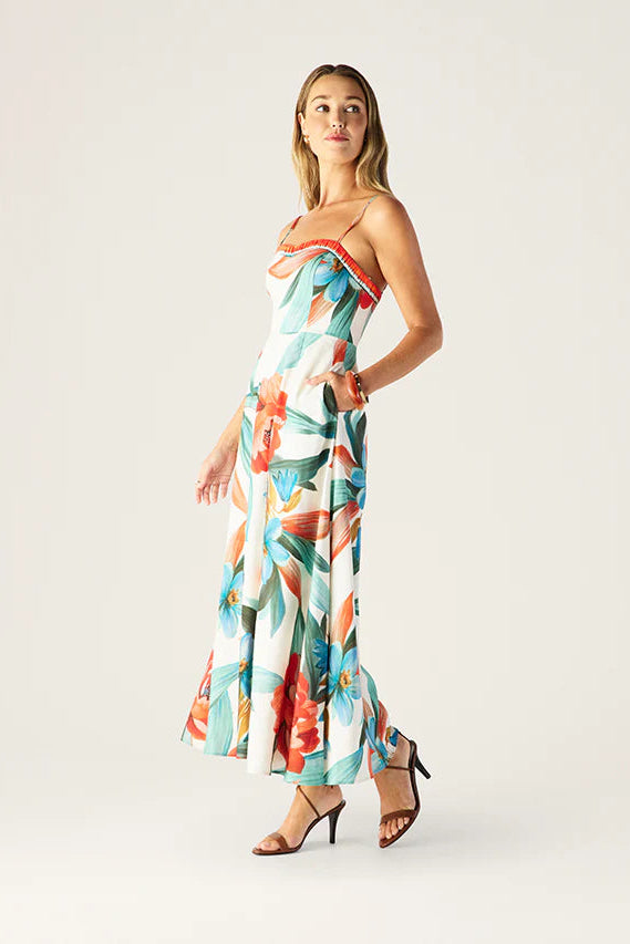 Woman wearing a colorful floral dress on a white background
