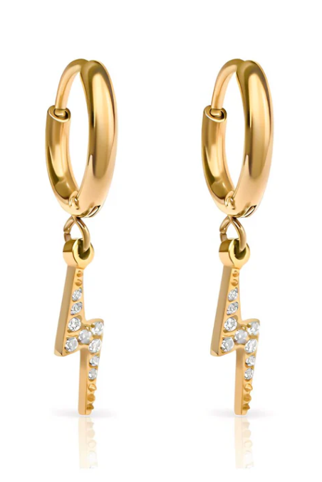 Gold hoop earring with a small diamond pendant worn by a person with blonde hair.