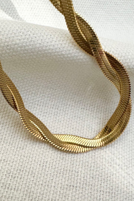 Gold chain on a white fabric background