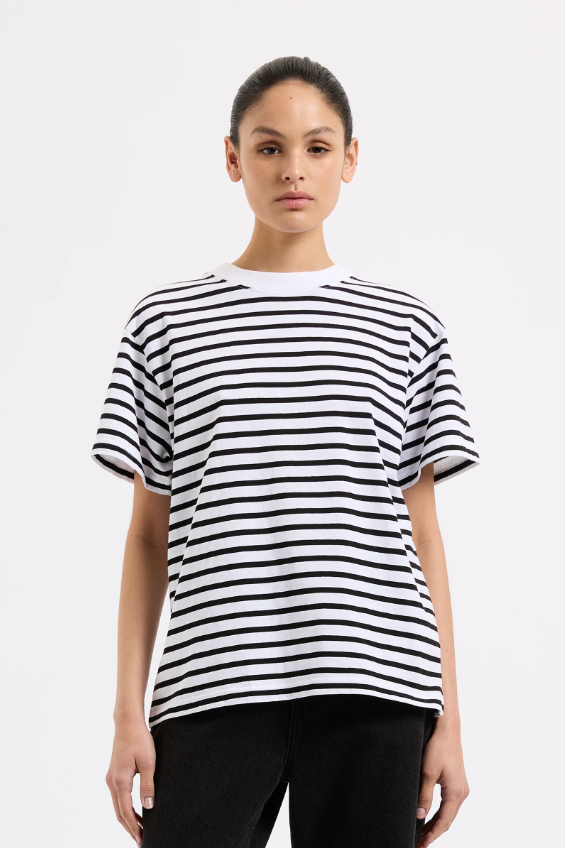 Person wearing a black and white striped t-shirt on a plain background