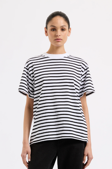 Person wearing a black and white striped t-shirt on a plain background