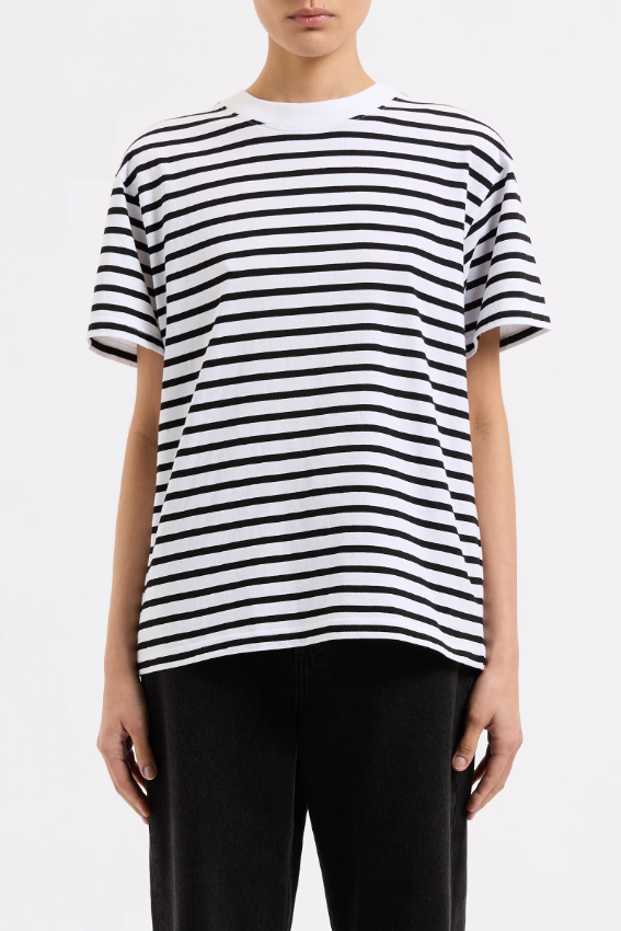 Person wearing a black and white striped t-shirt on a plain background