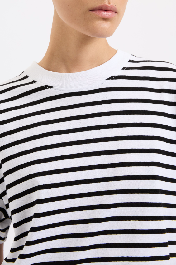 Close-up of a person wearing a black and white striped shirt.