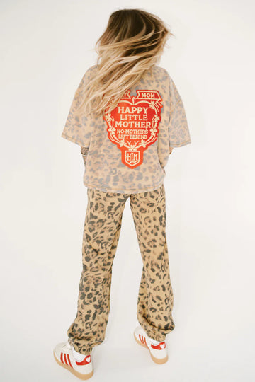 Person wearing a leopard print outfit with a graphic t-shirt on a white background